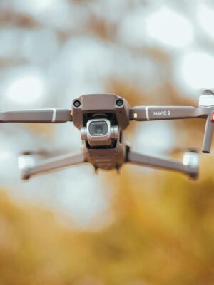 A sleek drone captured mid-air with blurred background, highlighting its advanced technology.