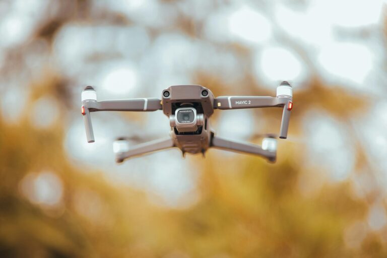 A sleek drone captured mid-air with blurred background, highlighting its advanced technology.