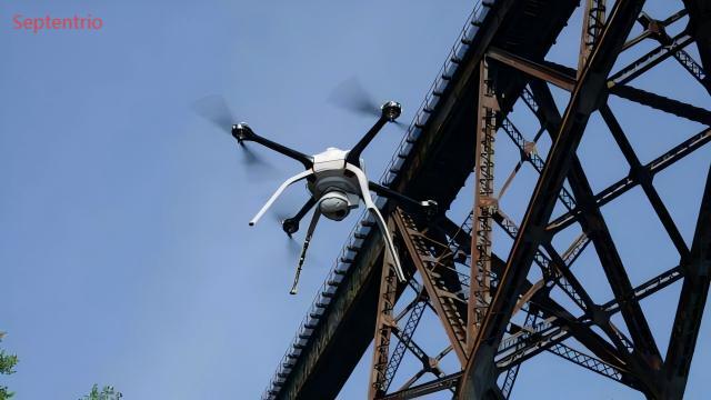 Drone flying near a bridge